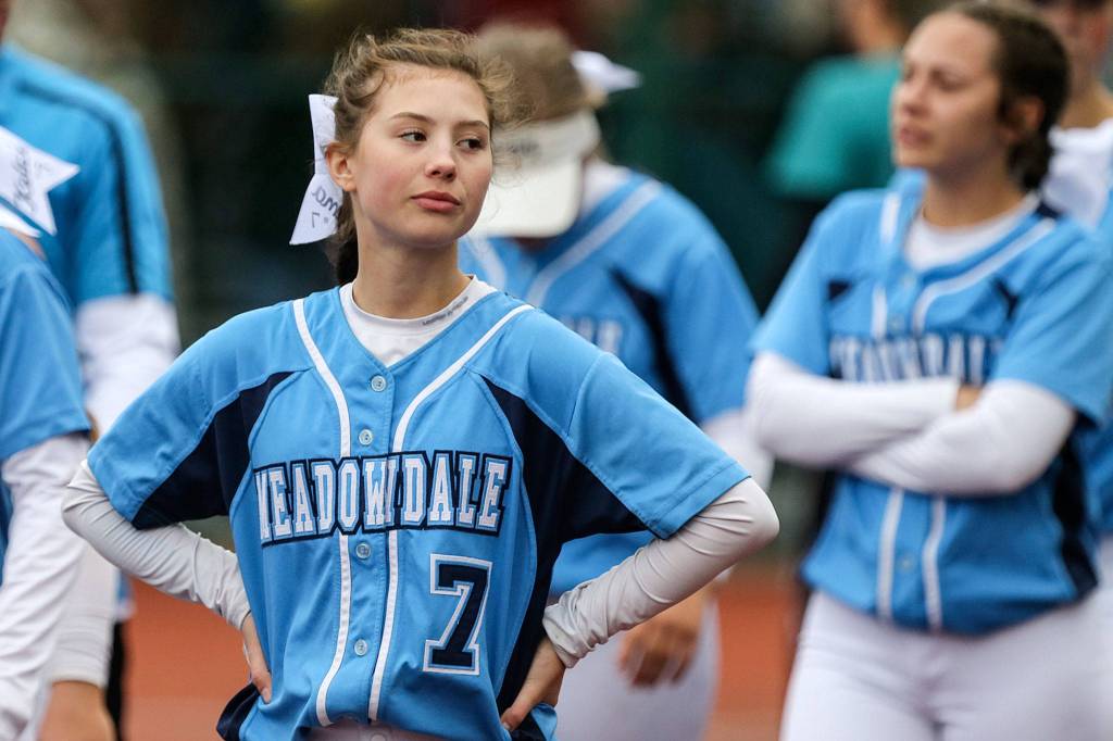 Meadowdales Emma Meyer walks off the field dejected with her team after losing to Bonney Lake during the 3A Softball State Championship at the Regional Athletic Complex in Lacey on May 24. (Kevin Clark / The Herald)
