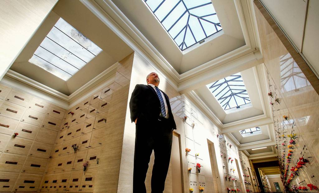 Pete Cameron, general manager of Evergreen Funeral Home and Cemetery, watches over View Crest Abbey Mausoleum where some of his ancestors are entombed. (Dan Bates / The Herald)