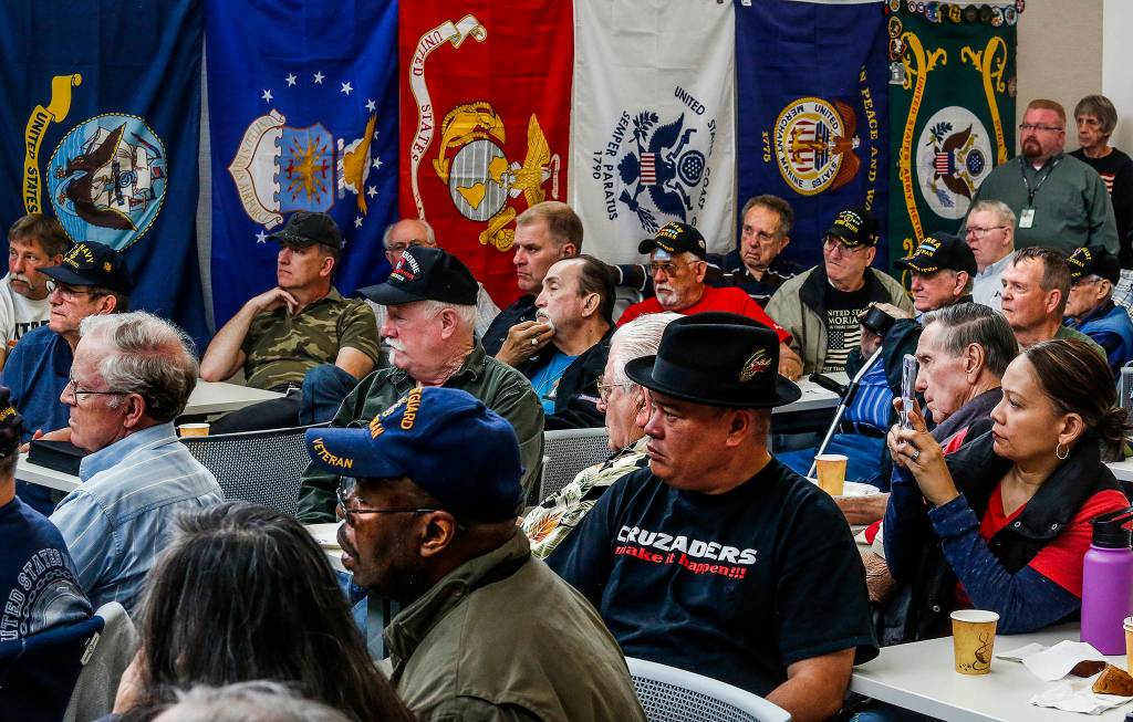 At the Heros Cafe in Lynnwood, more than 100 people listen to Michael Reagan, a veteran of the war in Vietnam. (Dan Bates / The Herald)