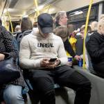 Passengers look at their smartphones as they ride a bus in Moscow, Russia. (AP Photo/Alexander Zemlianichenko)