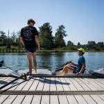 Dylan Stengel (left) and William Sweeney talk with Ethan Miedema (seated) as they get into their boat before a May 31 Everet Rowing Association practice on the Snohomish River in Everett. (Olivia Vanni / The Herald)