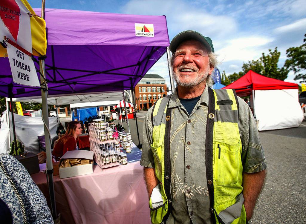 Gary Purves, a manager of the Everett Farmers Market during market hours Wednesday afternoon at Everett Station. There is no fee to park at the Wednesday market. (Dan Bates / The Herald)
