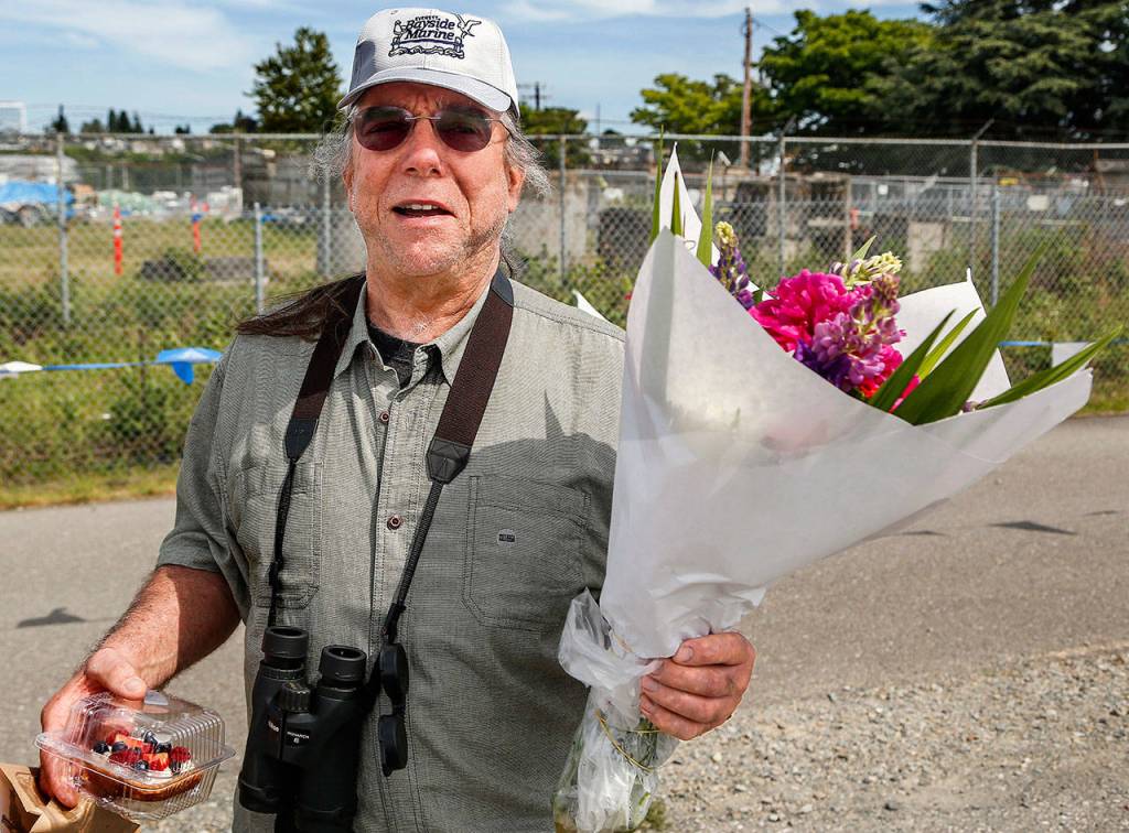 Jerry Miller, 66, carries his purchases from the Everett Farmers Market Sunday near Boxcar Park on the waterfront. He is unhappy about a new $2 fee to park at the market on Sundays. (Dan Bates / The Herald)