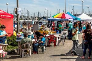Crowds were out Sunday at the Everett Farmers Market despite a new $2 parking fee imposed by the Port of Everett. (Dan Bates / The Herald)