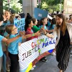 Kelsey Juliana, of Eugene, Oregon, a lead plaintiff who is part of a lawsuit by a group of young people who say U.S. energy policies are causing climate change and hurting their future, greets supporters outside a federal courthouse Tuesday, in Portland, Oregon. Three judges from the 9th U.S. Circuit Court of Appeals are hearing arguments from lawyers for 21 young people and the federal government in Portland but are not expected to rule right away. (AP Photo/Andrew Selsky)