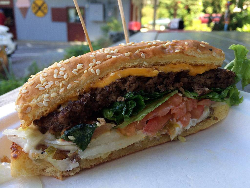 The Honeymoon Burger is a half-pound patty topped with mayonnaise, relish, onions, tomatoes and lettuce, and comes with large fries on the side. (Evan Thompson / The Herald)