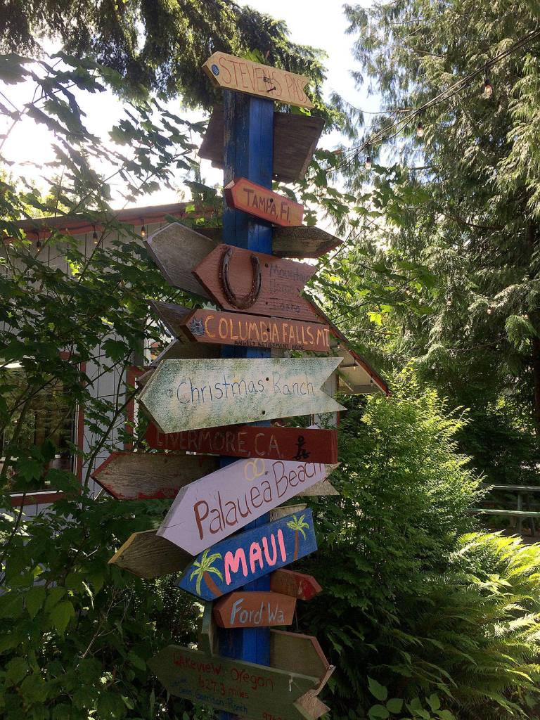 The drive-in has outdoor and indoor seating, as well as a few vintage mementos like these way signs. (Evan Thompson / The Herald)