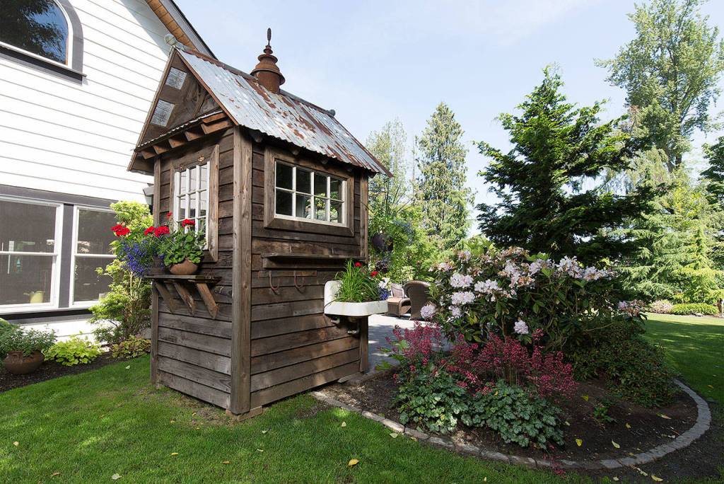 A small cabin, by Bob Bowling Rustics, sits in the back yard of Tom Astrofs home. (Andy Bronson / The Herald)