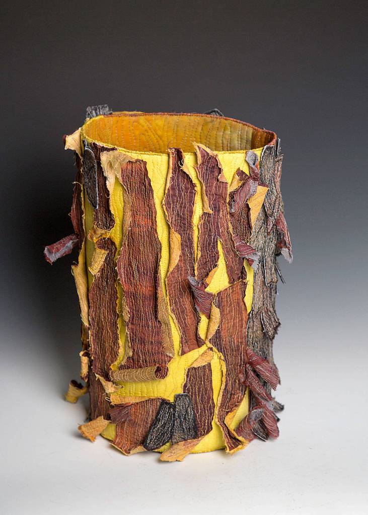 Madrone represents the peeling bark of a madrona tree. The 3-D vessel is made of hand-dyed fabric, threads and interfacing. It is hand- and machine-stitched.