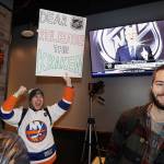 Max Rubin cheers and holds a sign in favor of the team name Kraken following the announcement in December that Seattle had been awarded an NHL expansion team. (AP Photo/Elaine Thompson)