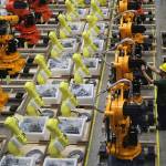 A worker checks on robot arms Thursday at a factory in Nanjing in east Chinas Jiangsu province. Chinas Commerce Ministry will release a list of unreliable foreign companies in the near future, a spokesman said Thursday, without giving a specific date. The new list, announced last week, is widely seen as a response to a U.S. decision to put Huawei Technologies on a blacklist for alleged theft of intellectual property and evasion of Iran sanctions. (Chinatopix via AP)