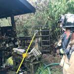 South Snohomish County Fire firefighters evaluate a home in Lynnwood after fire damaged it Monday morning. (South Snohomish County Fire)