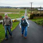 Cliff Bailey (center) and his son Don Bailey walk up Cliffs driveway on the familys 300-acre farm in Snohomish in March of 2016. (Ian Terry / The Herald)