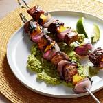 Chili-lime pork and mango skewers with avocado mash were inspired by the authors favorite street food. (Photo by Tom McCorkle for The Washington Post.)
