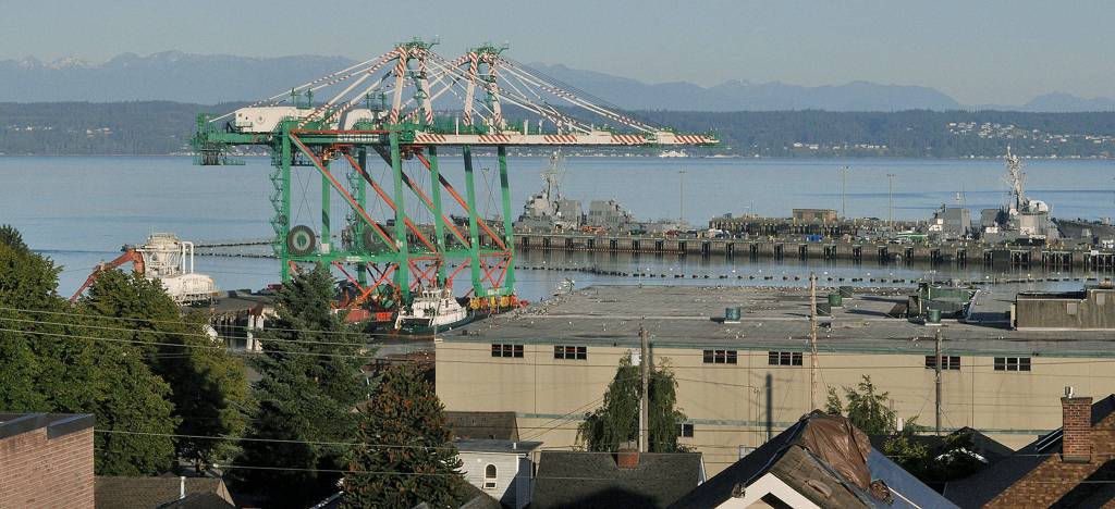 Waterfront residents awoke Tuesday to find a barge carrying a pair of cargo cranes tied up at the Port of Everett. (Sue Misao / The Herald)
