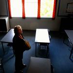 Carrying a scrapbook filled with photos and memories of former students, special education teacher Susan Dow is ready to leave her Monroe High classroom for the last time. (Dan Bates / The Herald)