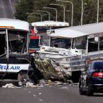 A Ride the Ducks amphibious tour bus and a charter bus are shown at the scene of a multiple fatality collision on the Aurora Bridge in Seattle on Sept. 24, 2015. A jury in Seattle has awarded $4 million in damages to a Montana woman for injuries she suffered after being ejected from a duck boat tour vehicle in a crash that killed five college students and injured dozens. The Seattle Times reported the jury awarded the money Monday to Rebecca Rhodes West, of Billings, Montana. (AP Photo/Elaine Thompson, File)