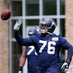 The Seahawks Duane Brown tips away a football during a practice on May 21, 2019, in Renton. (AP Photo/Elaine Thompson)