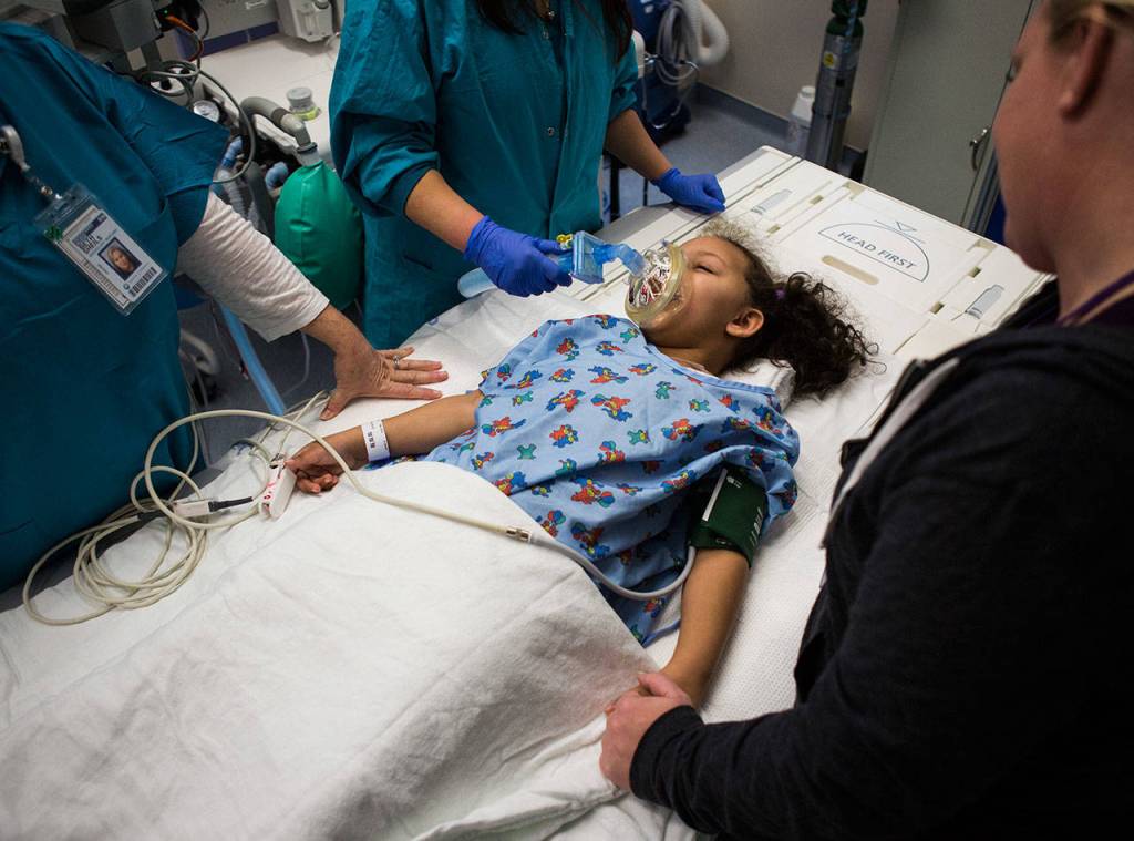 Kaya receives anesthesia before her MRI brain scan at Seattle Childrens Hospital on Dec. 12, 2018. This is Kayas first time getting scans since she finished her radiation treatment in July. (Olivia Vanni / The Herald)