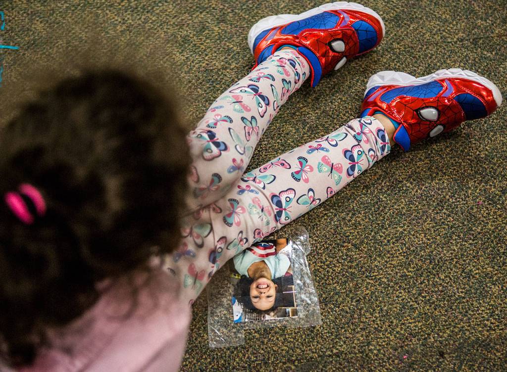 Kaya sits down next to her floor seat picture wearing her favorite Spiderman shoes during class at Emerson Elementary on Jan. 22 in Everett. (Olivia Vanni / The Herald)
