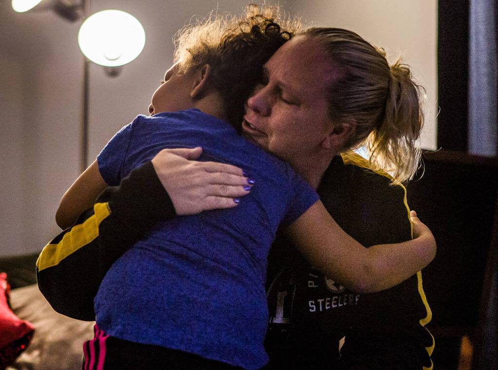 Kaya hugs her mother as she becomes emotional while explaining Kayas DIPG diagnosis on Nov. 14, 2018, at their home in Everett. (Olivia Vanni / The Herald)