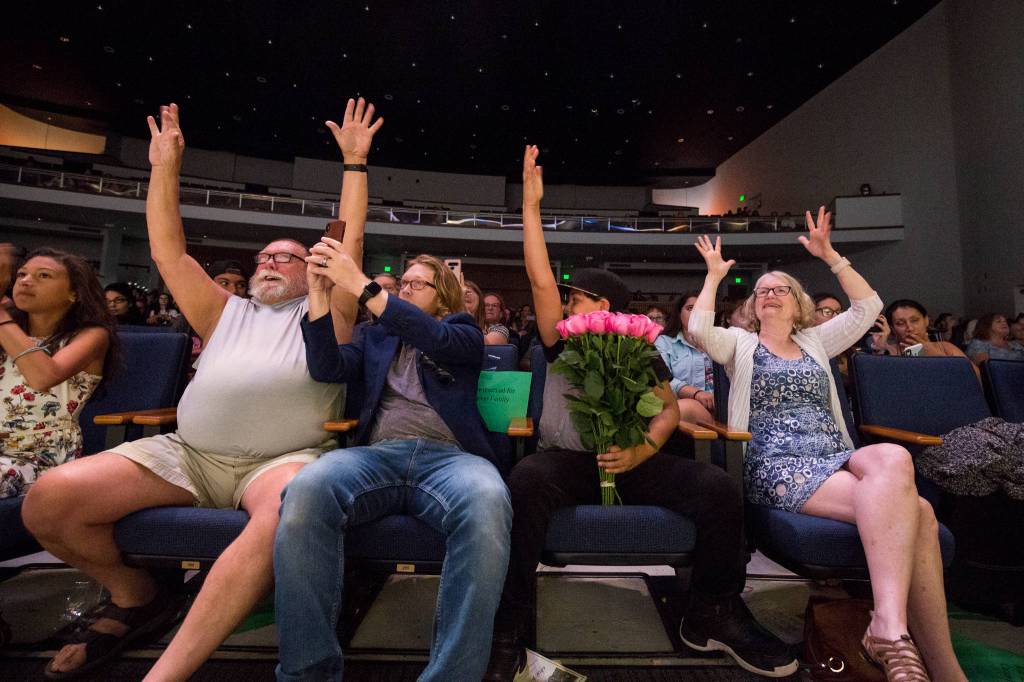 Family members cheer for a graduate at the Sequoia High graduation ceremony held in the Everett Civic Auditorium on Thursday, June 13, 2019 in Everett, Wash. (Andy Bronson / The Herald)