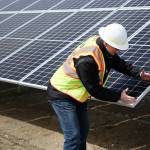 Project manager Scott Gibson demonstrates the approximate size of one unit. (Julia-Grace Sanders / The Herald)