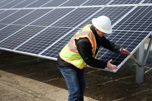 Project manager Scott Gibson demonstrates the approximate size of one unit. (Julia-Grace Sanders / The Herald)