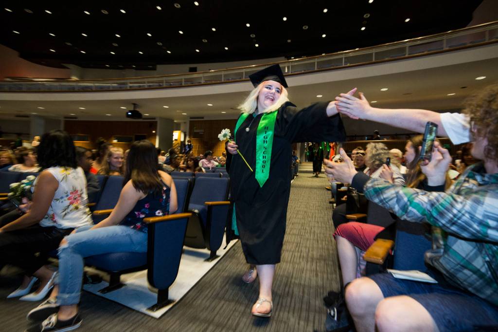 Alexzandrea Coggins gets high fives as she walks down the aisle at the <a href="https://www.heraldnet.com/news/gallery-sequoia-high-graduation-class-of-2019/" target="_blank">Sequoia High graduation ceremony</a> held in the Everett Civic Auditorium on June 13 in Everett. (Andy Bronson / The Herald)