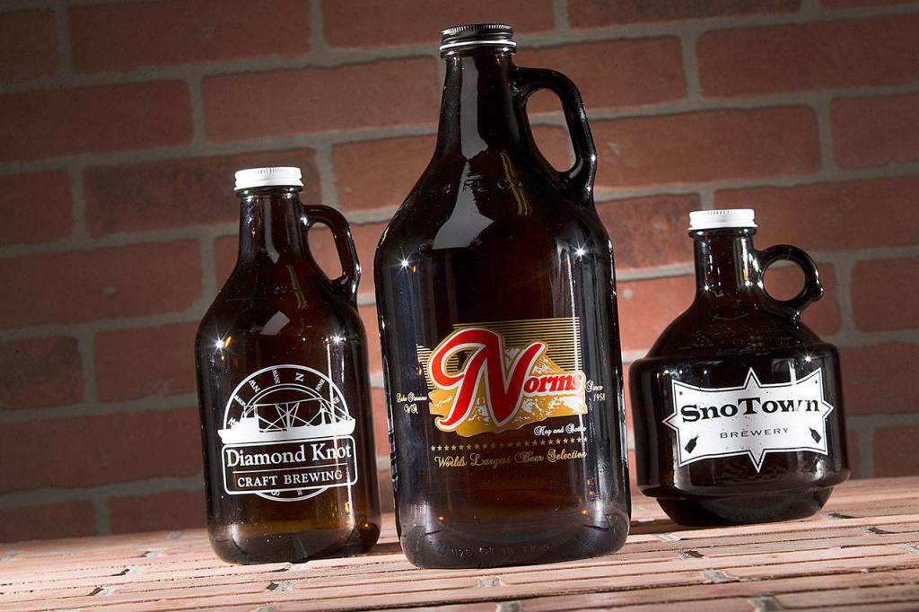<strong>Glass.</strong> These are the growlers most people are familiar with. Brown, made of glass and simple. They most often come in 64 ounces (Norms Market), but 32 ounces (Diamond Knot) also is popular. Variants include the giant German style with a fliptop lid  Scuttlebutt orders them from Germany  or the squat 32-ouncer, a favorite at SnoTown. (Andy Bronson/ The Herald)