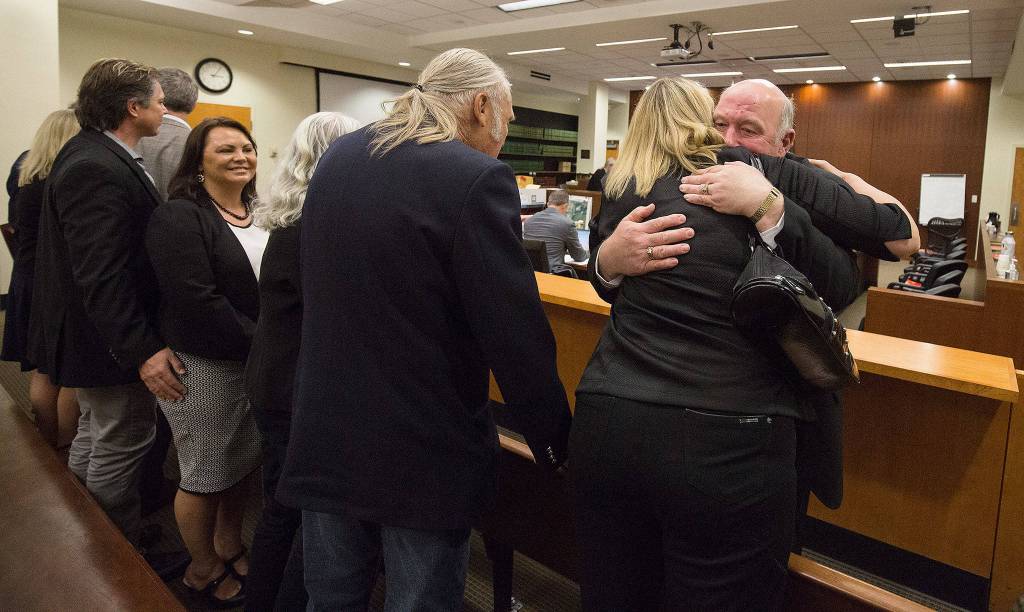 Jim Scharf, Snohomish County Sheriffs Office cold case detective, gets a hug from Kelly Cook after his testimony Thursday naming William Talbott II as being linked to the DNA in the case, at the Snohomish County Courthouse in Everett. (Andy Bronson / The Herald/POOL)