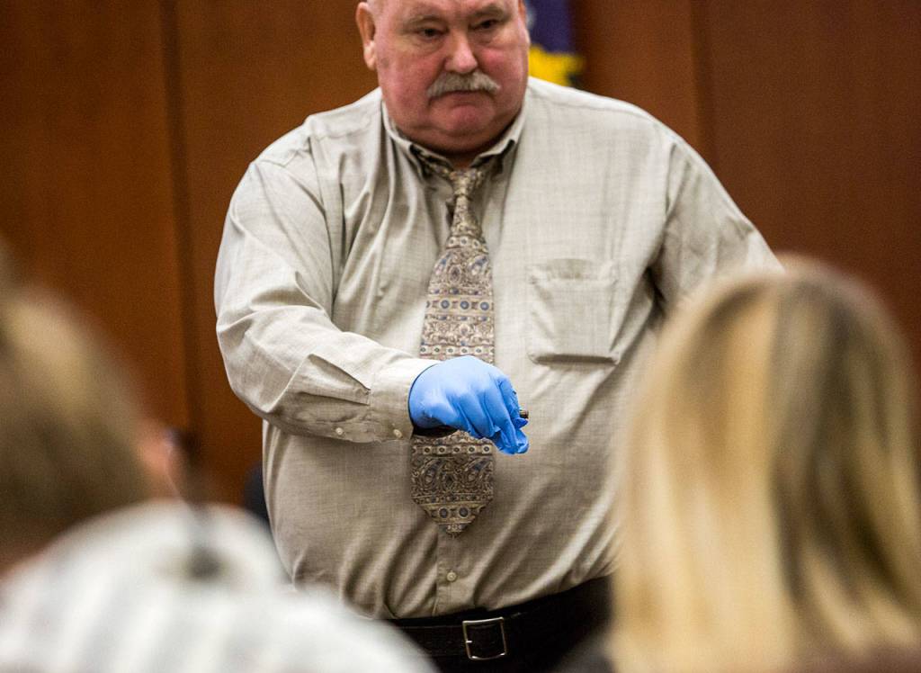 George Smith, a retired Skagit County sheriffs deputy, shows the jury a bullet casing that was found near Tanya Van Cuylenborgs body, during the trial of William Talbott II on Wednesday at the Snohomish County Courthouse in Everett. (Olivia Vanni / The Herald)