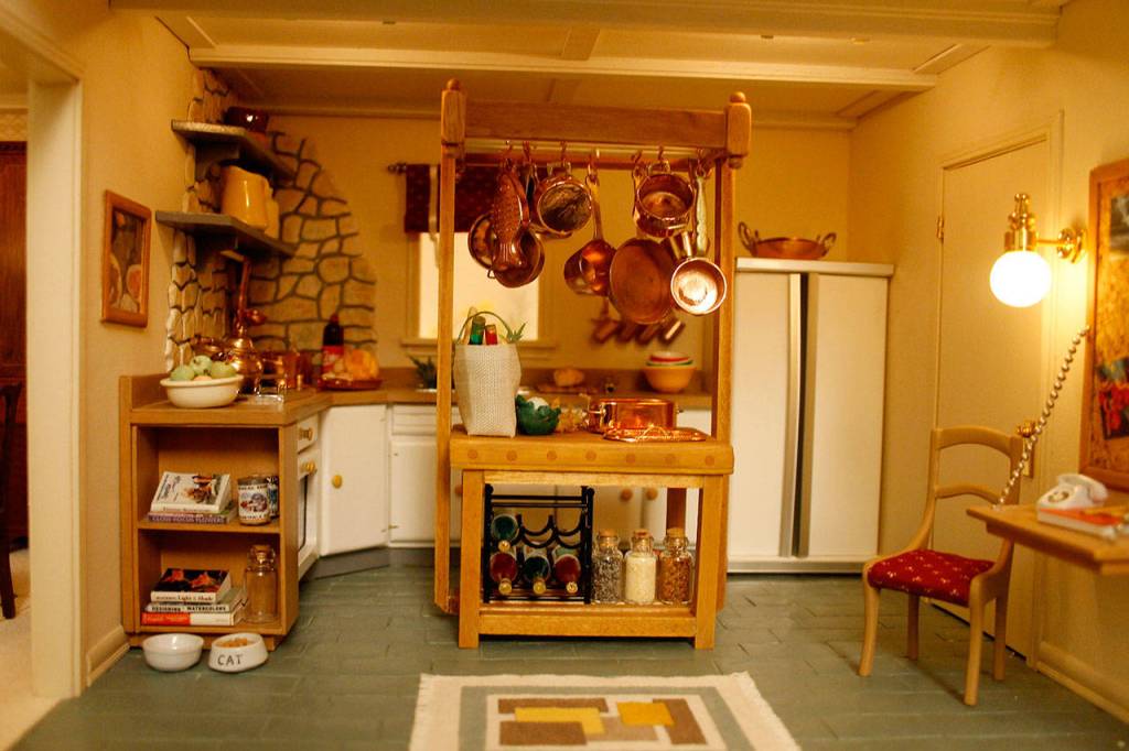In the kitchen, the doors of the refrigerator open to reveal fully-stocked shelves. (Maria Matson / Whidbey News-Times)
