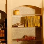 The music room bookshelf contains small books with titles such as Dracula, White Fang and Phantom of the Opera. (Maria Matson / Whidbey News-Times)