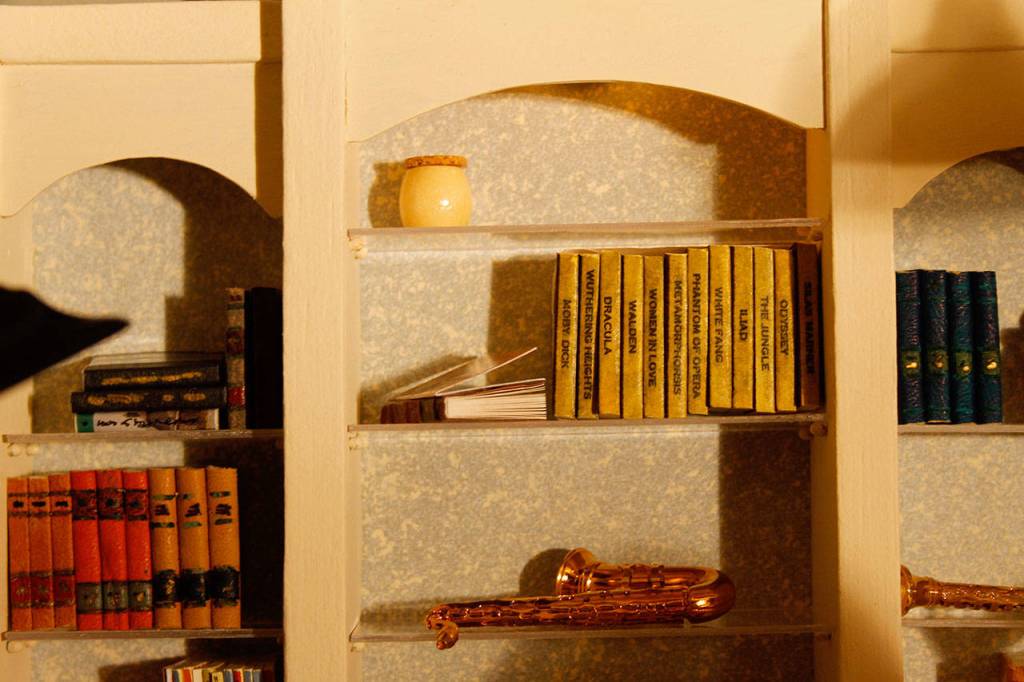 The music room bookshelf contains small books with titles such as Dracula, White Fang and Phantom of the Opera. (Maria Matson / Whidbey News-Times)