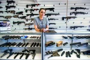 Tiffany Teasdale, co-owner of Lynnwood Gun & Ammunition, talks about new requirements that take effect Monday, due to voters approval of Initiative 1639. (Dan Bates / The Herald)