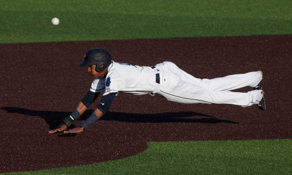 The AquaSoxs Miguel Perez dives into second base during Everetts home opener against the Volcanoes on June 21, 2019, at Funko Field at Everett Memorial Stadium. (Andy Bronson / The Herald)