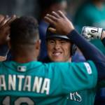 The Mariners Dylan Moore (right) celebrates with teammate Domingo Santana after hitting a solo home run during the second inning of a game against the Oriokes on June 21, 2019, in Seattle. (AP Photo/Stephen Brashear)