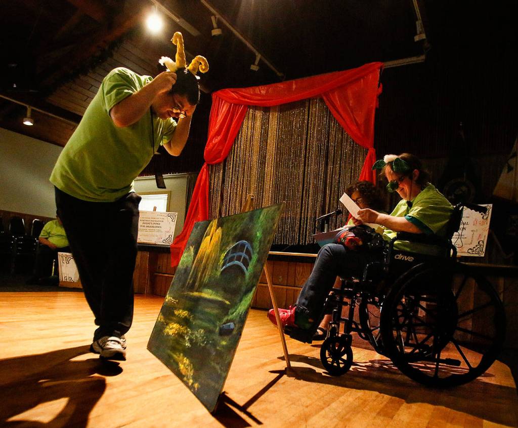 Emily Martinek (nearest right) reads her lines as she plays the troll in The Three Billy Boats Gruff Wednesday at the Knights of Columbus hall in Everett. Nick Butler, playing the biggest goat, approaches the bridge at left. (Dan Bates / The Herald)