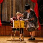 Show director Heidi Heimarck helps singer-guitarist Megan Harrell at the start of Way Off Broadway, a talent show staged by All Aboard. The nonprofit provides recreation and other programs for adults with special needs. (Dan Bates / The Herald)