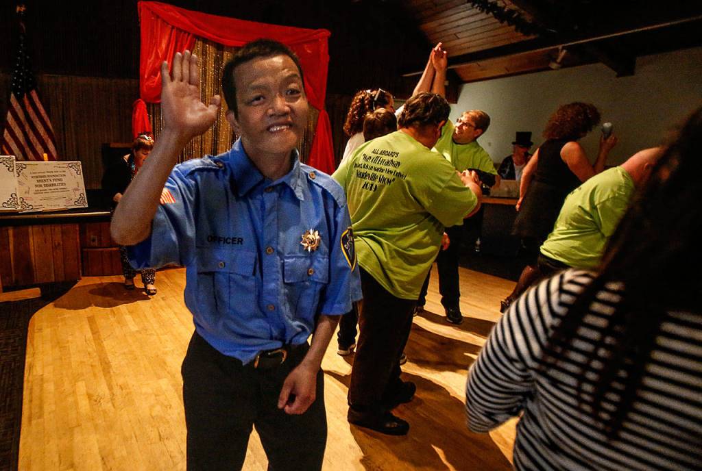 Sam Lu, after his raucus performance of Bad Boys, celebrates the end of All Aboards talent show with other cast members Wednesday night at the Knights of Columbus hall in Everett. (Dan Bates / The Herald)