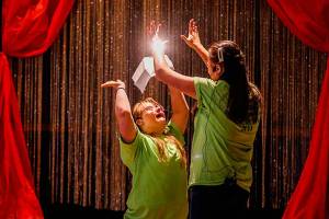 At the end of a rousing performance of the song You Are Holy, Faith Fitch (left) and Angelina Nesterenko end with a high-five. (Dan Bates / The Herald)