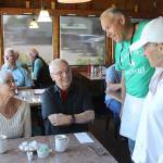 Freeland Cafes new owners, Jeff and Deb Kennelly, talk to customers during a busy Fathers Day Sunday breakfast. (Patricia Guthrie/South Whidbey Record)