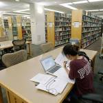 A student works in the library at Virginia Commonwealth University in Richmond on June 20. Those who graduate college with student loans owe close to $30,000 on average, according to the most recent data from the Institute for College Access & Success. (AP Photo/Steve Helber)