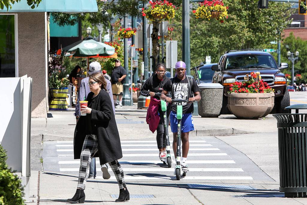 In May, 100 rentable e-scooters were placed in Everett and since have been whizzing down sidewalks in the city. (Lizz Giordano / The Herald)