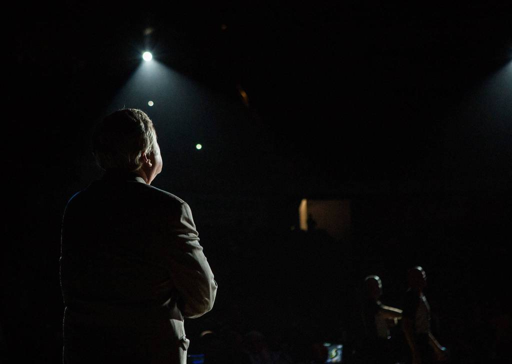 Seattle Storm head coach Dan Hughes stands in the spotlight before the game against the Los Angeles Sparks at Angel of the Winds Arena on June 21 in Everett. (Olivia Vanni / The Herald)