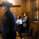 An Oregon state trooper stands guard as Oregon State Republican Sen. Brian Boquist waits with his wife, Peggy, to walk onto the Senate floor Sunday in Salem. Democratic Sen. Shemia Fagan said Sunday that some Democrats are demanding Republican Sen. Brian Boquist not be allowed to return to the floor. Boquist drew criticism for saying police should come heavily armed if they tried to return him to the Capitol amid a GOP walkout over climate legislation. (AP Photo/Sarah Zimmerman)