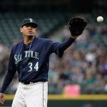 Mariners starting pitcher Felix Hernandez reaches for a ball against the Tigers in the first inning of a game May 18, 2018, in Seattle. (AP Photo/Elaine Thompson)