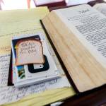 Handwritten notes and letters sit next to an open Bible at the Wayside Chapel. (Olivia Vanni / The Herald)