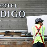 A construction worker cuts steel at Hotel Indigo during construction at the Port of Everetts Waterfront Place last month. (Kevin Clark / The Herald)